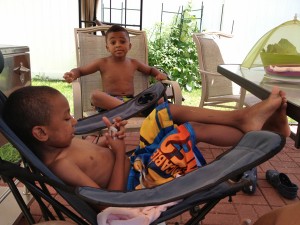 Apollo taking a break from the pool to play charades with cousin Alessandro.